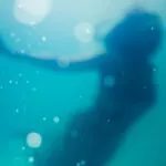 woman swimming under body of water